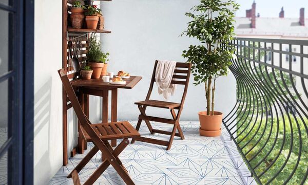 Small balcony with plants and a simple chair